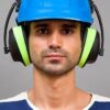 An image showing a man wearing PPE including ear defenders and a hard hat